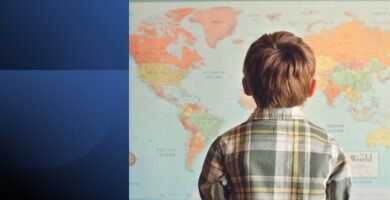 Person looking at world map representing the power to dream big and set visionary goals for success.