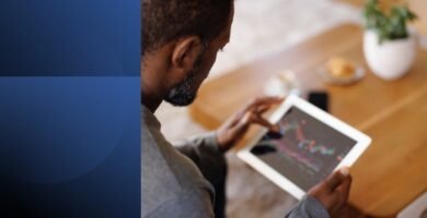 A man using a tablet to apply productivity tactics and manage his time effectively.