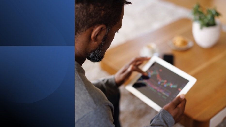 A man using a tablet to apply productivity tactics and manage his time effectively.