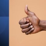 Man giving thumbs-up gesture representing the dangers of saying yes and overcommitment.