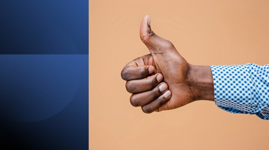 Man giving thumbs-up gesture representing the dangers of saying yes and overcommitment.